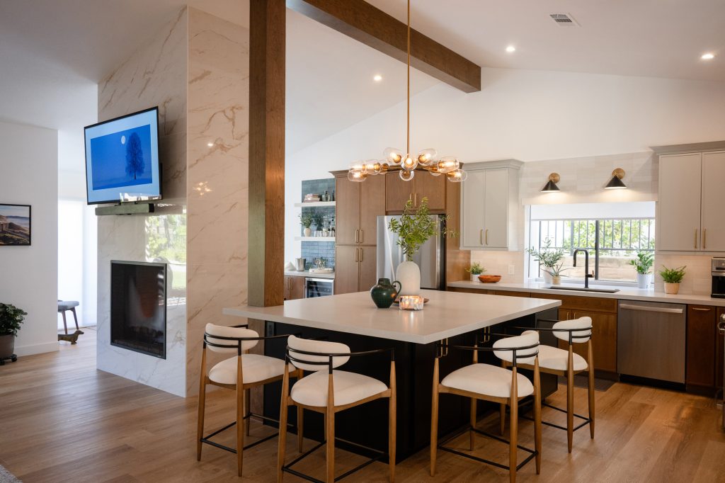 Wide view of the kitchen, island, and fireplace