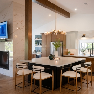 Wide view of the kitchen, island, and fireplace