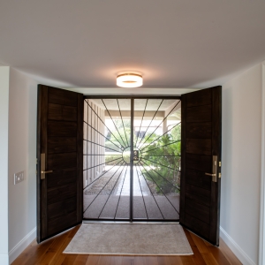 Interior view of dark wood front entry doors in Rancho Bernardo remodel