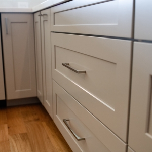 Oatmeal shaker kitchen cabinets with brushed metal hardware