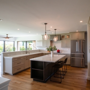 Open-concept kitchen with island seating and white oak hardwood floors