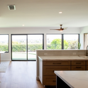 Open kitchen and living area with white oak flooring and widened opening