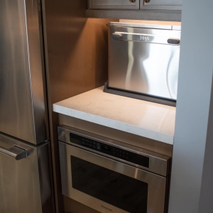 Appliance garage holding a countertop oven above a built-in microwave drawer