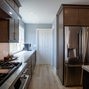 View down the kitchen with the range on the left and the french door refrigerator on the right