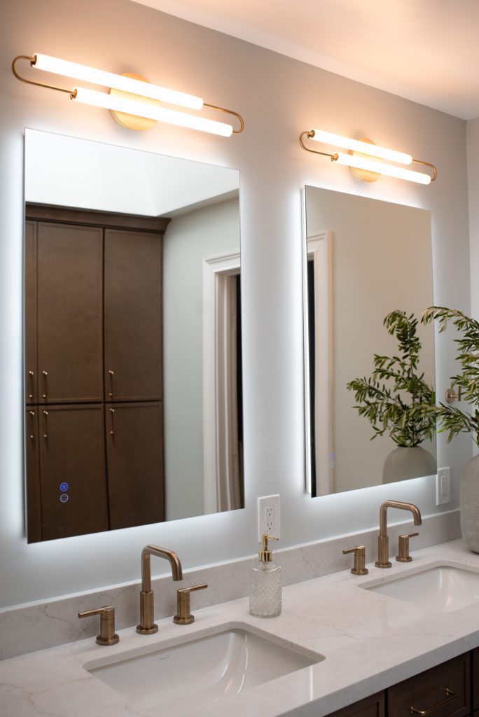 Two brass widespread faucets at undermount sinks on a Calacatta Valentin quartz counter