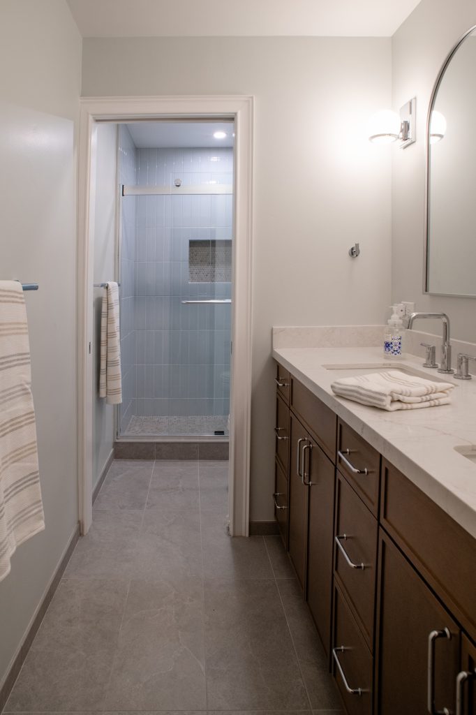 Looking down the room past the vanity to the shower behind its own doorway