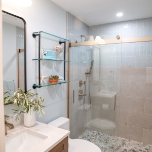 Tall view from the vanity toward the shower, with a recessed light and exhaust fan overhead