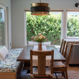 Built-in banquette with a patterned cushion running along two windows