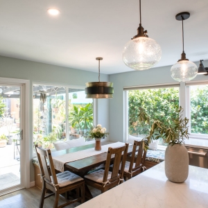 Dining area with pendants, sconces, and the sliding doors to the garden