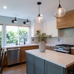 Green island with quartz top, sink run behind it, and the range at the right