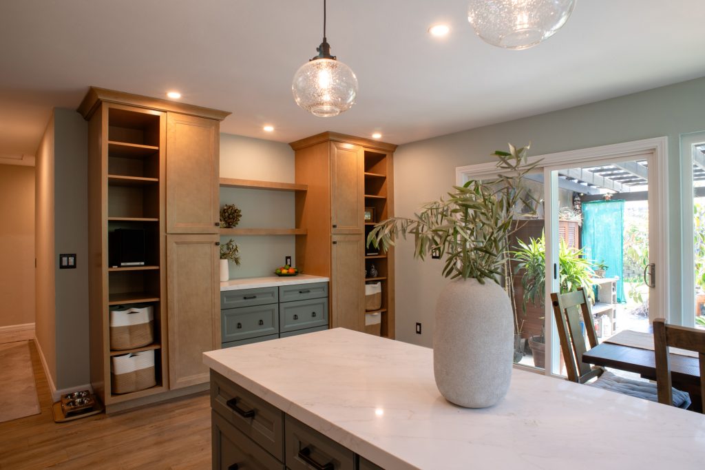 New wall of built-in pantries and buffet cabinetry with open shelving in a Mira Mesa kitchen