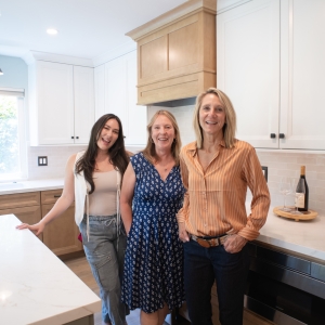 Designers Andrea and Haley with the client after the remodel