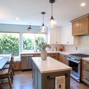 Full kitchen view from the dining side, island and range wall with pendants above