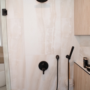Delta rain shower head, valve, and handheld in dark bronze on onyx-look tile