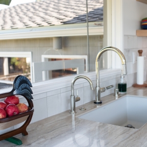 Polished nickel Brizo kitchen faucet and beverage faucet at the sink