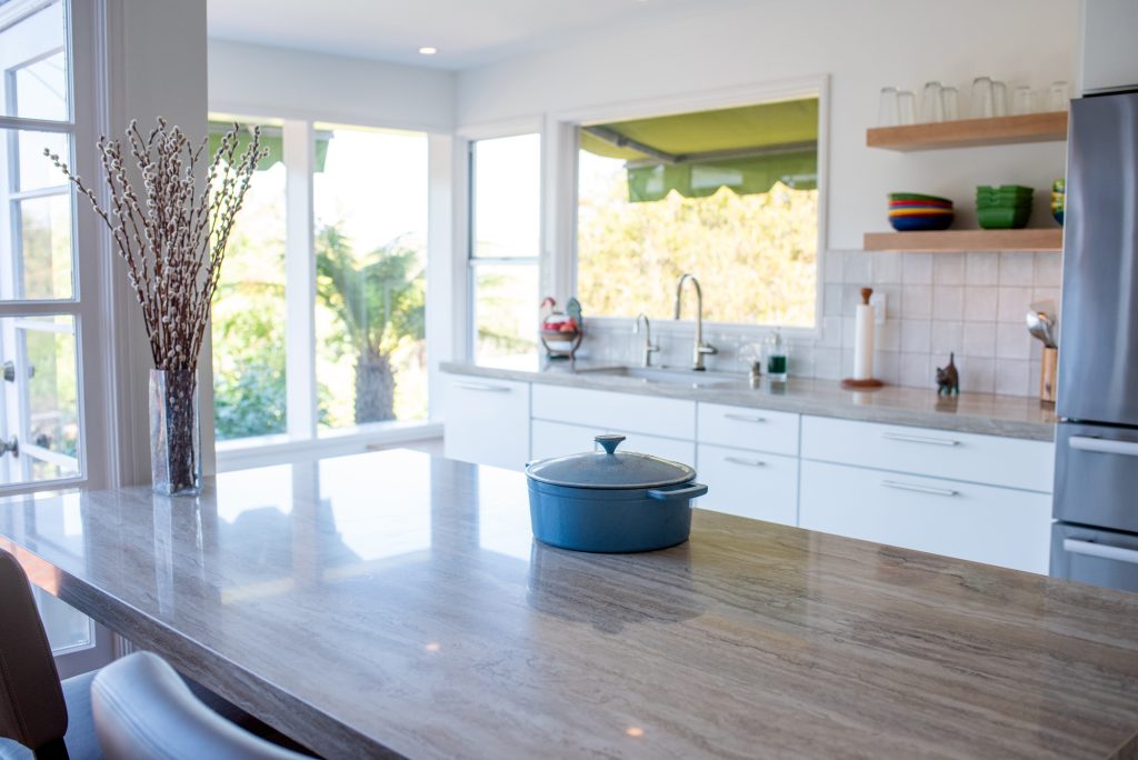 Cooking directly on the porcelain countertop over a hidden induction cooktop in a Point Loma kitchen