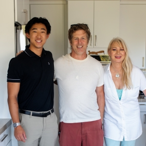 Three people standing together in the finished kitchen