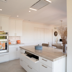 Tilt-down panel in the island opened to reveal the induction cooktop controls