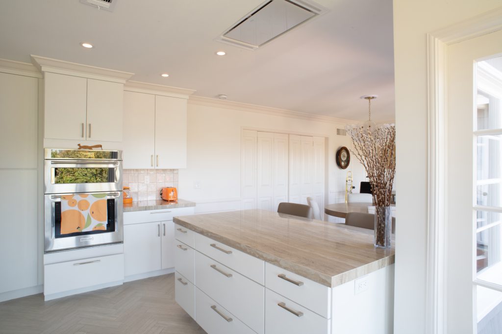 Kitchen peninsula below a flush-mounted ceiling range hood in a remodeled Point Loma kitchen