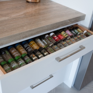 Pull-out drawer lined with rows of spice jars